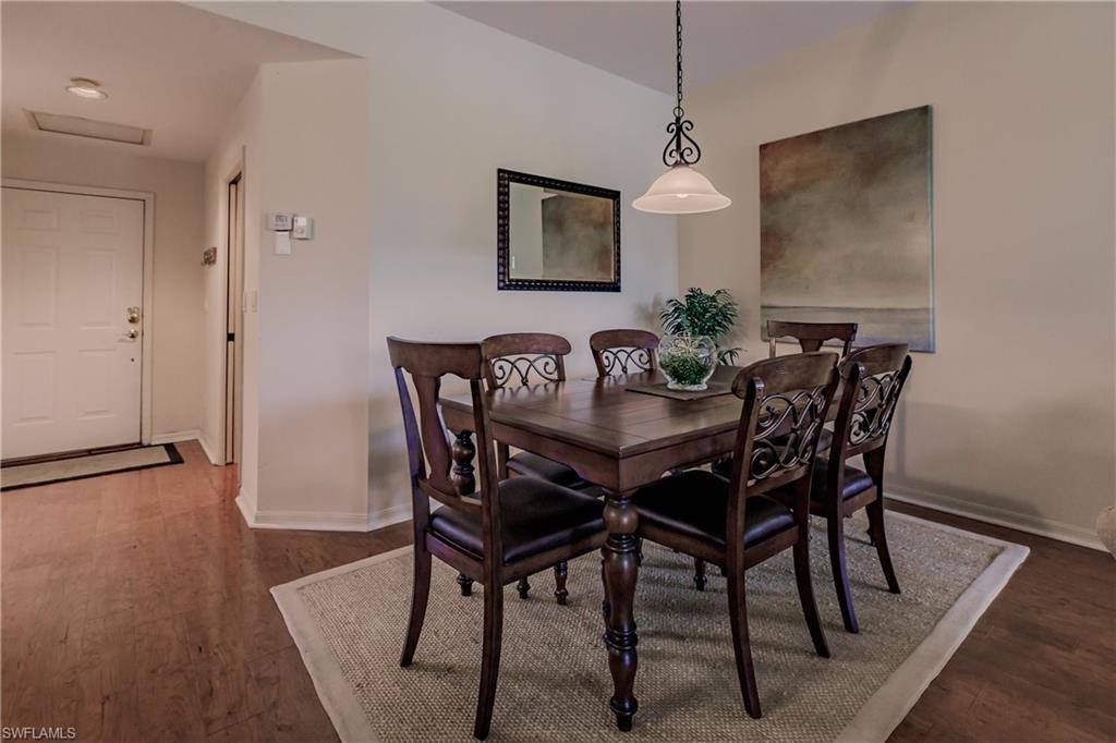 Dining room with dark hardwood / wood-style flooring