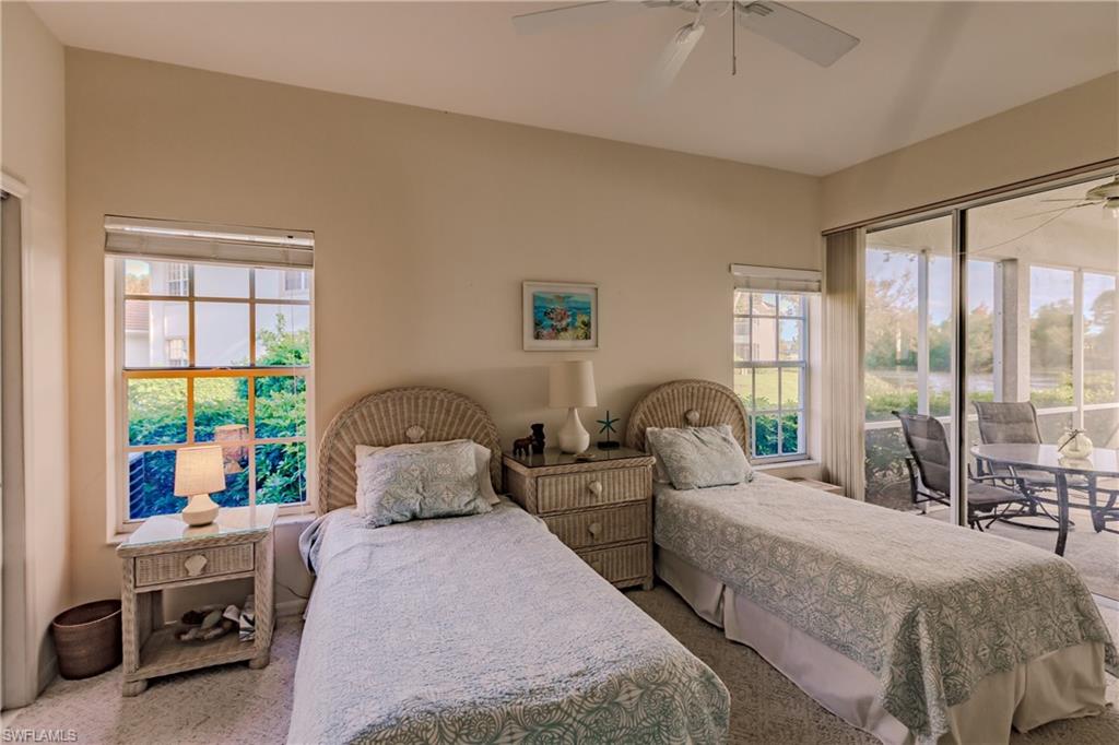 Carpeted bedroom featuring multiple windows, access to outside, and ceiling fan