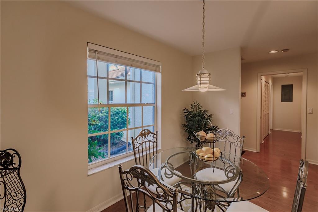 Dining room with electric panel and dark hardwood / wood-style floors