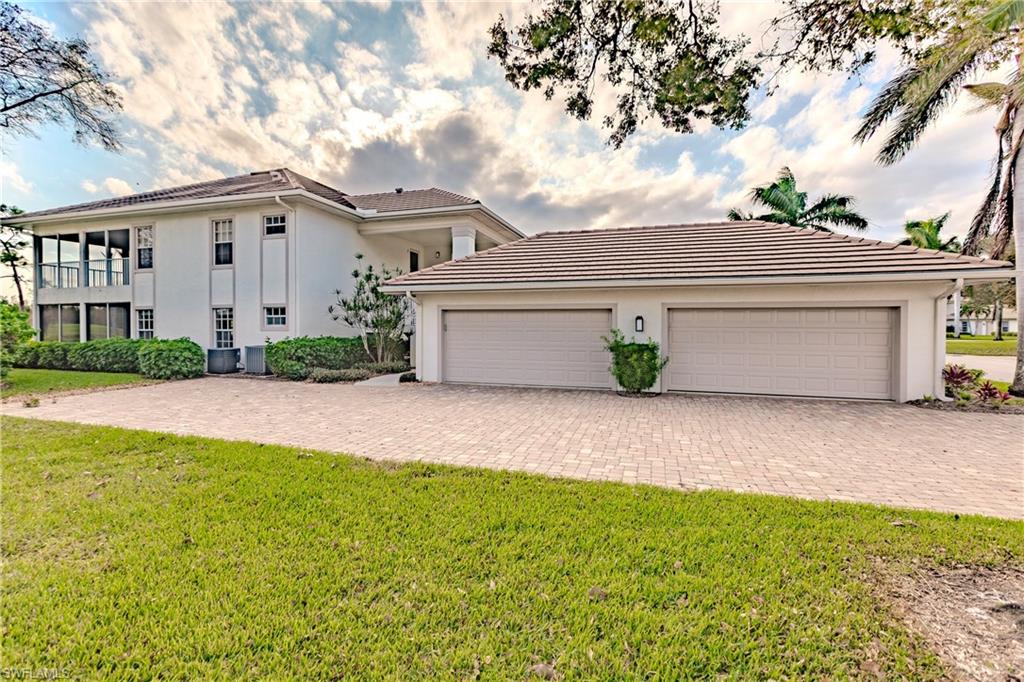 Mediterranean / spanish house with a front yard and a garage