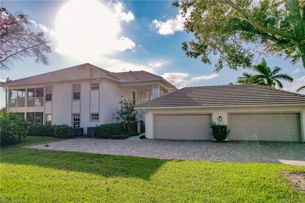 Mediterranean / spanish house featuring a front lawn, central AC, and a garage