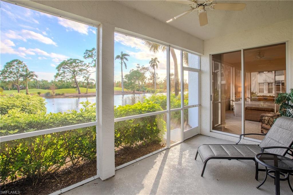 Sunroom featuring a water view and ceiling fan