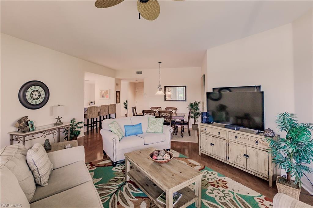 Living room featuring wood-type flooring and ceiling fan