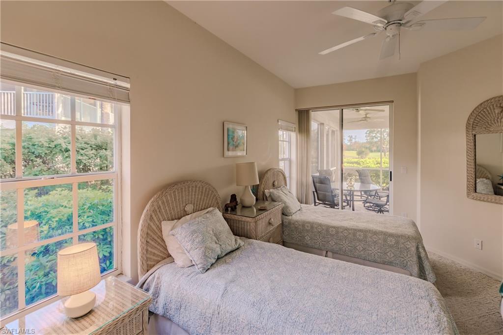Carpeted bedroom with vaulted ceiling and ceiling fan