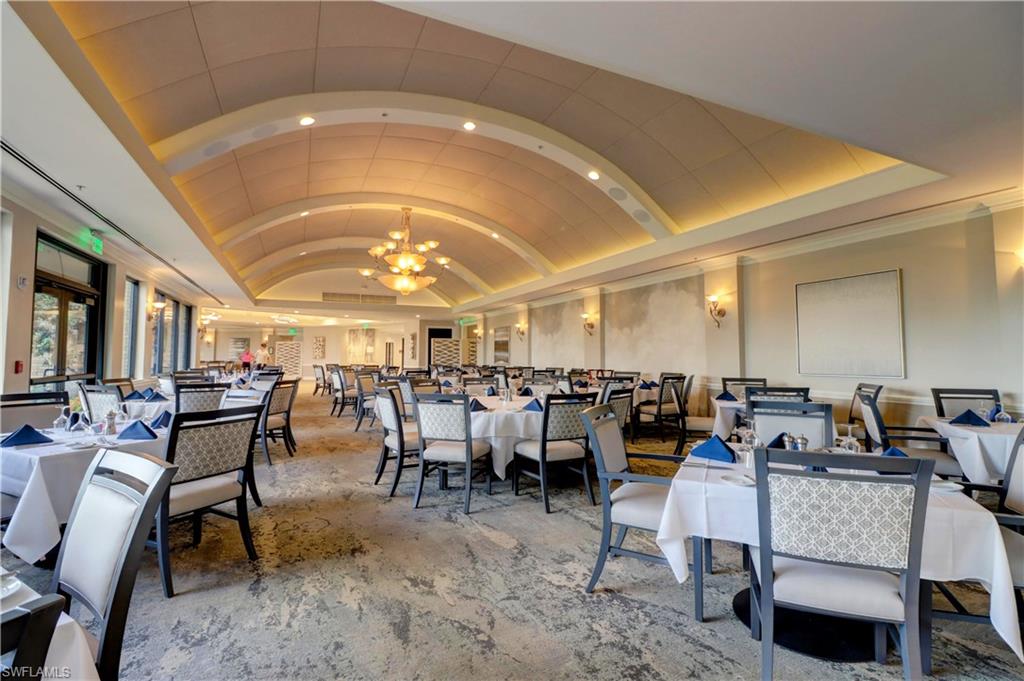 Dining area with vaulted ceiling and an inviting chandelier