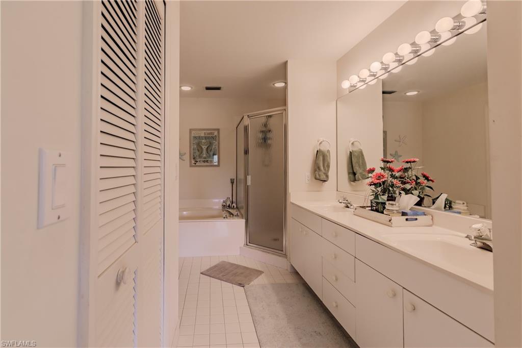 Bathroom featuring vanity, tile patterned floors, and separate shower and tub