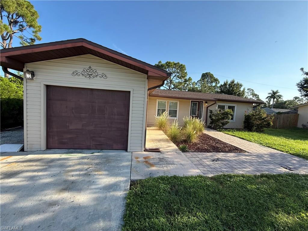 Attached single-car garage with a concrete driveway