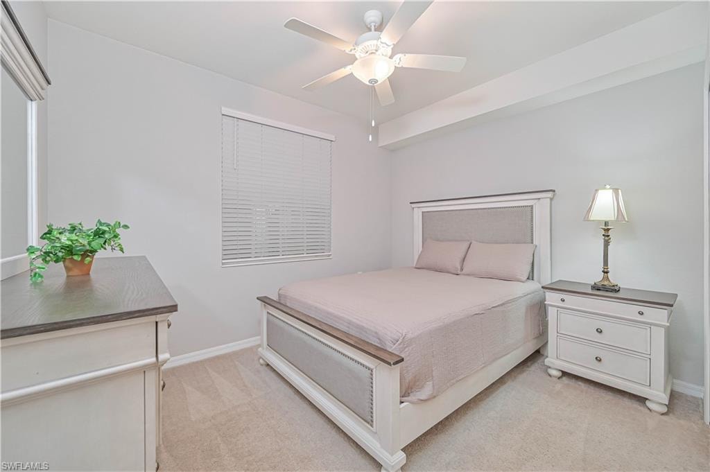 Comfortable guest bedroom featuring plush carpeting, neutral finishes, abundant natural light, and a spacious closet—ideal for family or overnight guests.