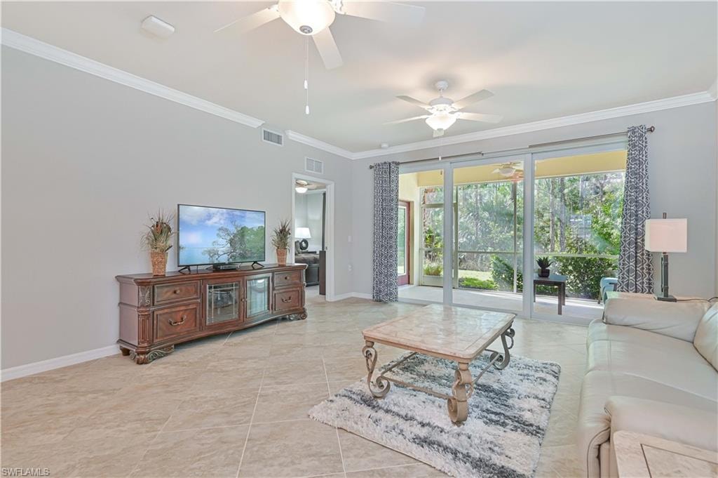Light-filled great room with soaring ceilings, crown molding, diagonal tile flooring, and oversized sliding glass doors that seamlessly connect to the screened lanai and peaceful preserve views.