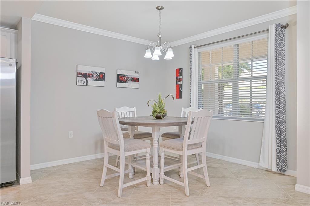Sunlit dining area with a large picture window, elegant lighting, and an open-concept design that seamlessly connects to the kitchen—perfect for casual meals or entertaining.