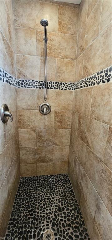 Full bath featuring a tile shower