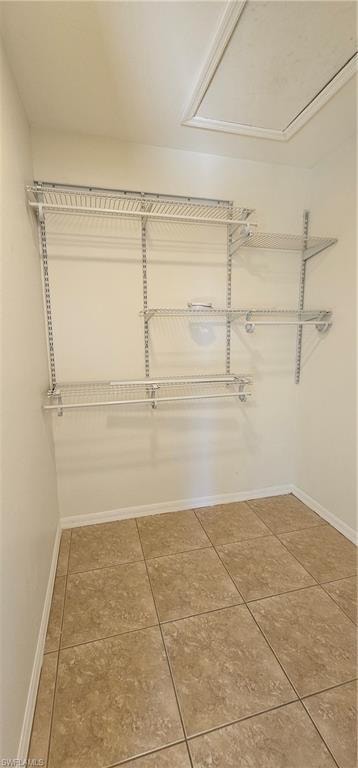 Walk in closet featuring light tile patterned floors