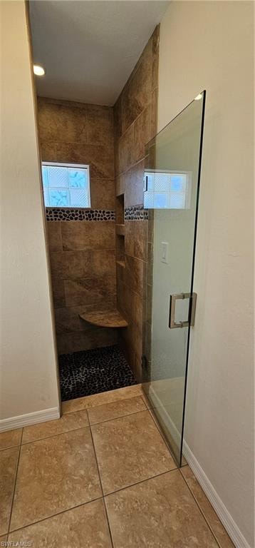Full bathroom featuring a stall shower, light tile patterned floors, and recessed lighting