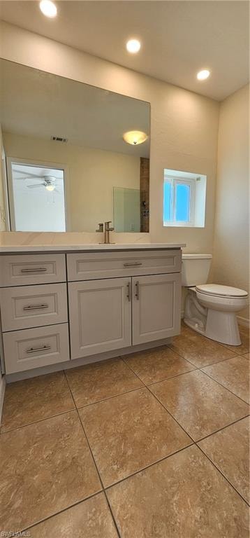 Bathroom featuring vanity, recessed lighting, light tile patterned floors, and a shower