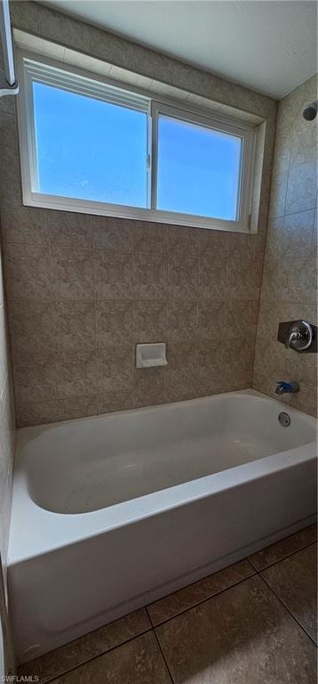 Full bath with plenty of natural light, shower / bathtub combination, and tile patterned flooring