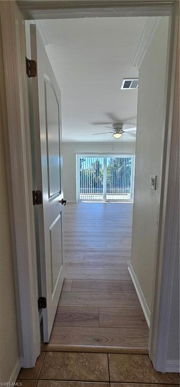 Corridor featuring baseboards and light wood-style floors