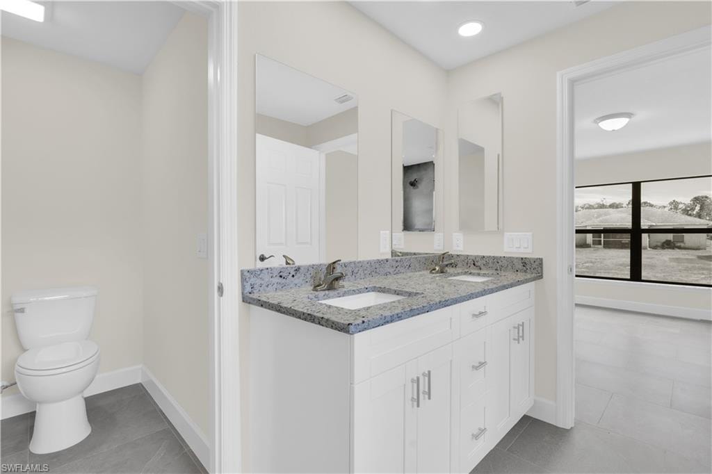 Dual vanity with light-colored countertops, white cabinetry, and undermount sinks