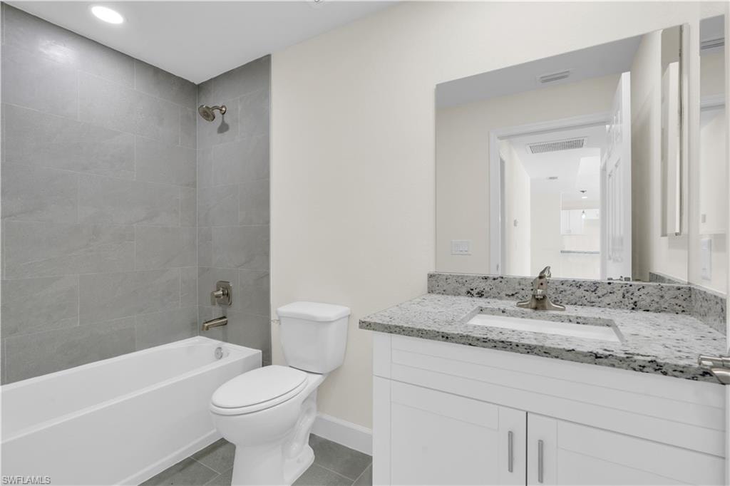 Modern vanity with granite-style countertop, undermount sink, and brushed nickel faucet