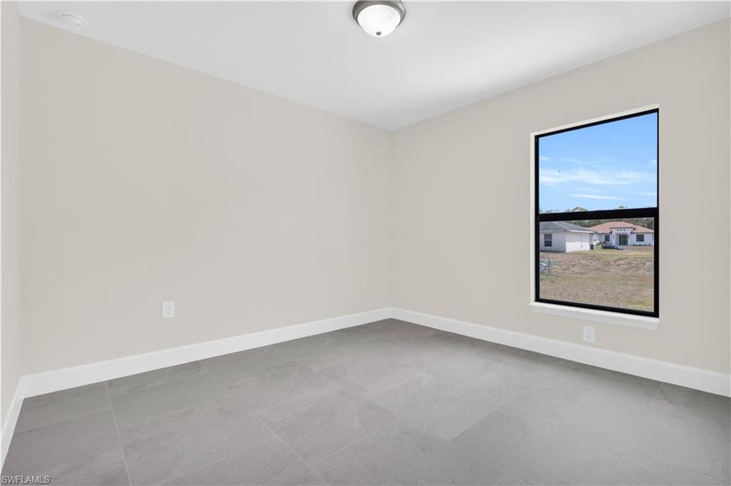 Neutral tone wall paint, contemporary tile flooring, recessed window, ceiling-mounted light fixture, and white trim