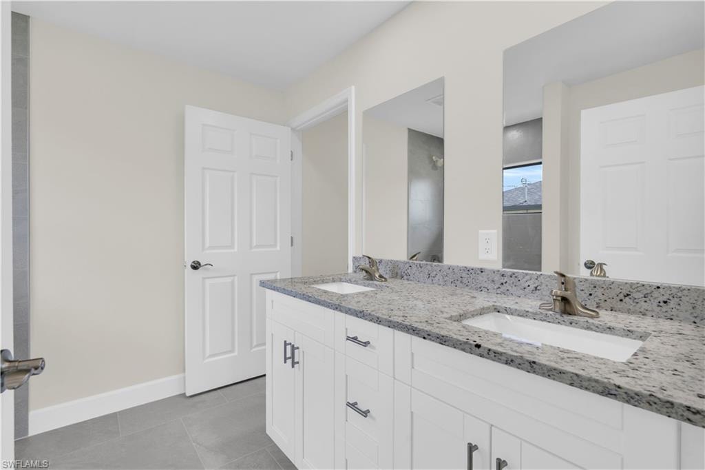 Dual vanity with speckled countertop, undermount sinks, and brushed nickel fixtures