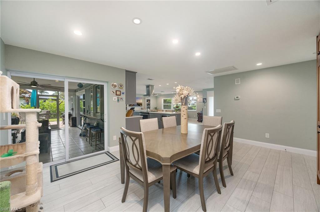 Recessed lighting, light wood-finish flooring, sliding glass doors, built-in cabinetry, and neutral wall tones