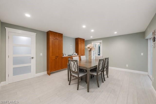 Recessed lighting illuminates wood-finish flooring