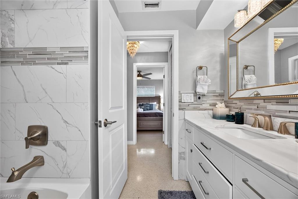 3rd bathroom tub/shower w/access to pool, across the hall from 3rd bedroom