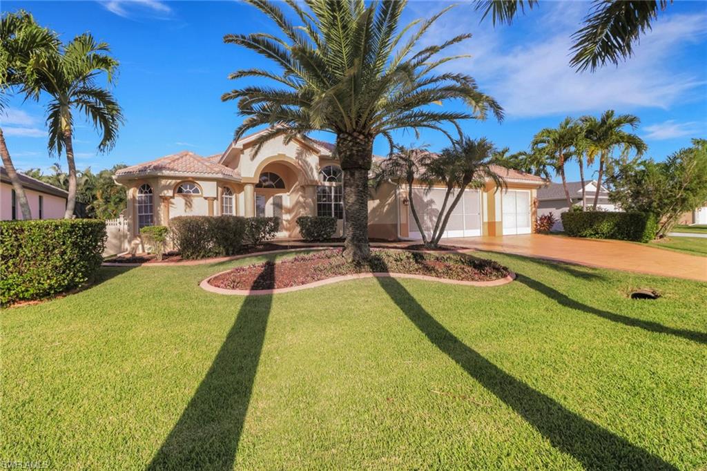 Mediterranean / spanish-style home with stucco siding, driveway, a front lawn, and an attached garage