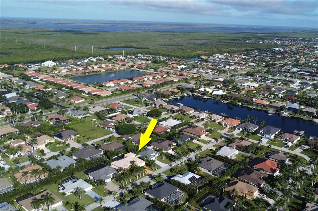 Aerial view of property's location with nearby suburban area and a large body of water