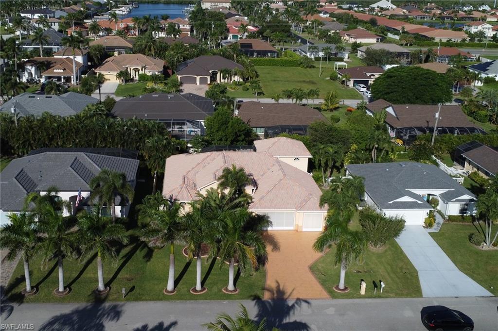 Aerial view of property's location with nearby suburban area