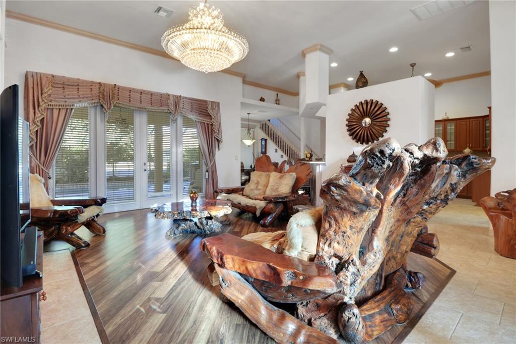 Living room featuring ornamental molding, recessed lighting, stairway, and french doors