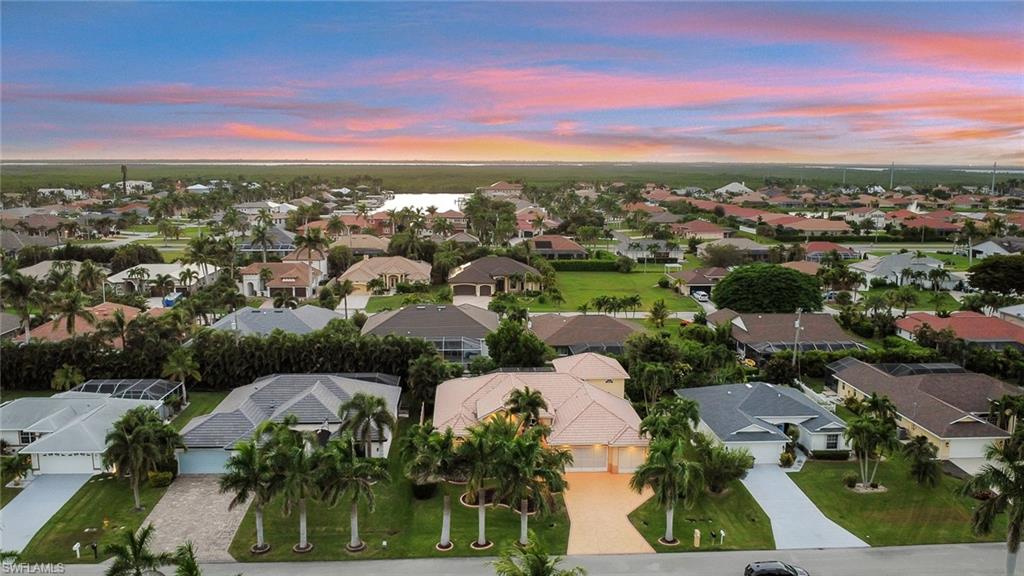 Aerial perspective of suburban area with a nearby body of water