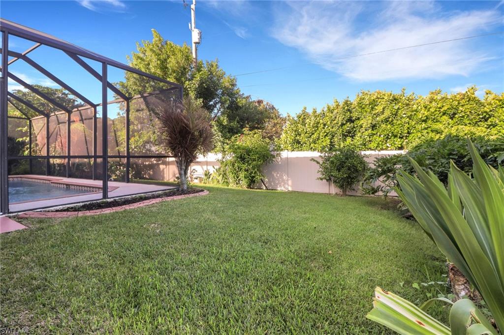 Fenced backyard with glass enclosure, a sunroom, an outdoor pool, and a patio area