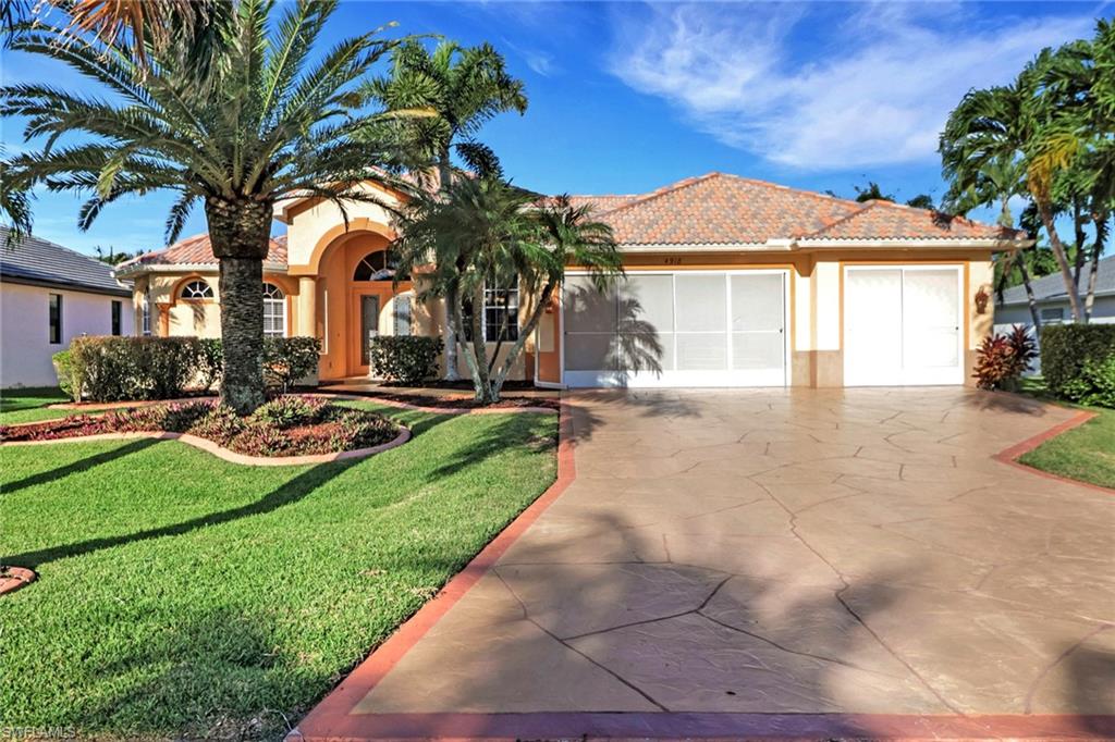 View of front of home featuring a front lawn, a tiled roof, stucco siding, driveway, and an attached garage