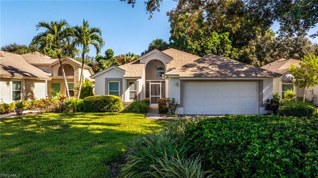 Stucco exterior with a hip roof, arched entryway with screened enclosure, and an attached two-car garage