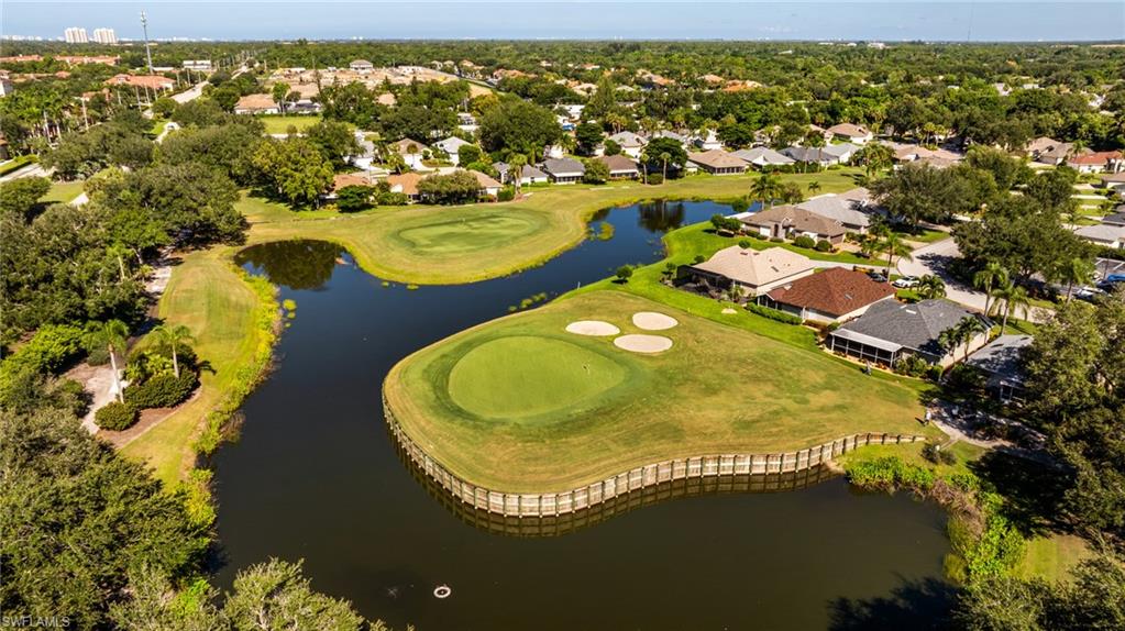 Expansive golf course frontage with mature landscaping, water features, and established residences
