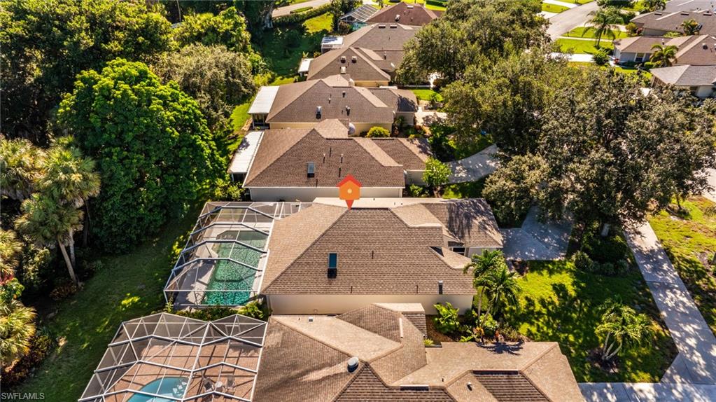 Screened pool area, mature landscaping, paved pathways, and lush green spaces