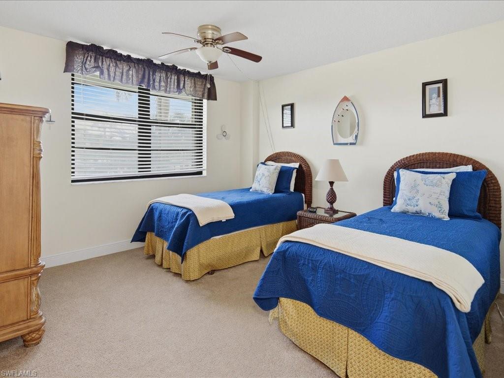 Wall-to-wall carpeting and a ceiling fan with light fixture