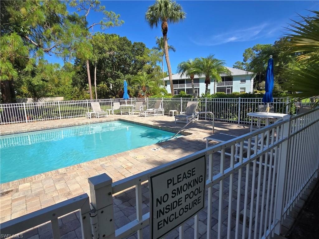 Paved pool deck features an in-ground swimming pool with room to enjoy relaxation while tanning