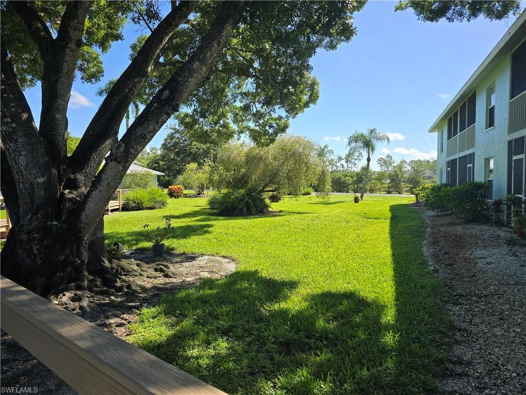 Expansive green lawn with mature trees and landscaping