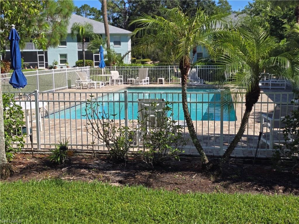 Just outside your lanai is the swimming pool with a paved deck, surrounded by mature palm trees and landscaping