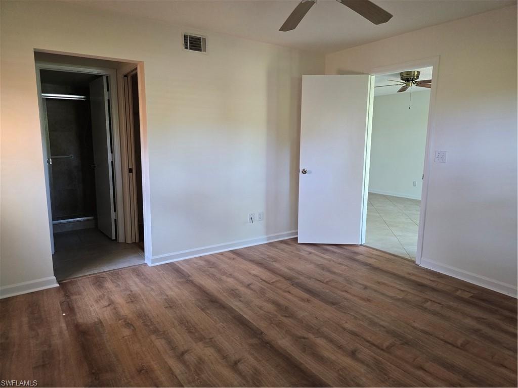 Wood-finish flooring and entrance to bathroom and walk in closet