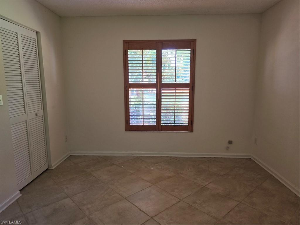 Middle bedroom with closet and plantation shutters