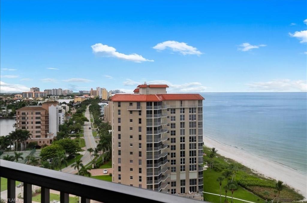 View of building exterior featuring view of water and beach