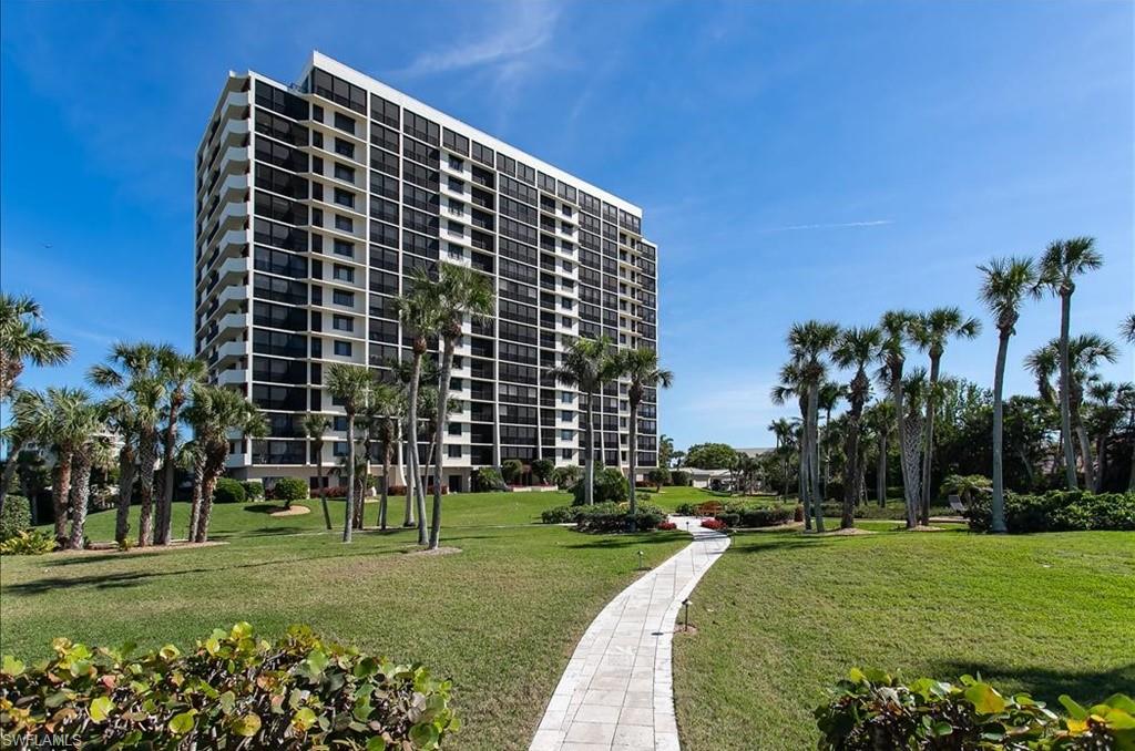 View of property's community with a lawn