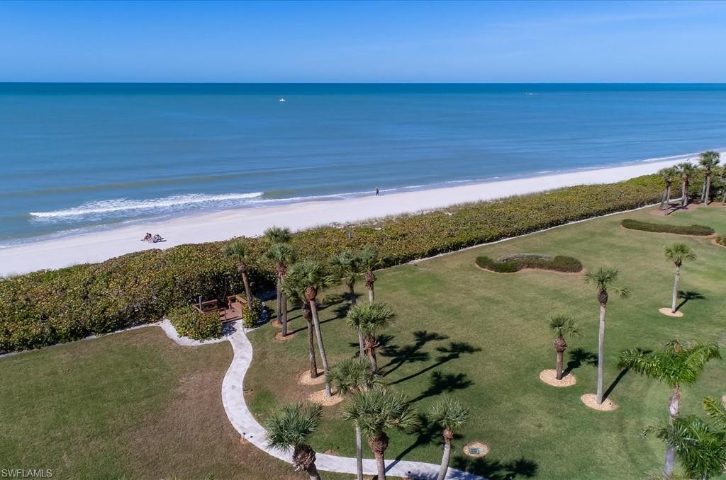 Aerial view of property and surrounding area with expansive coastline