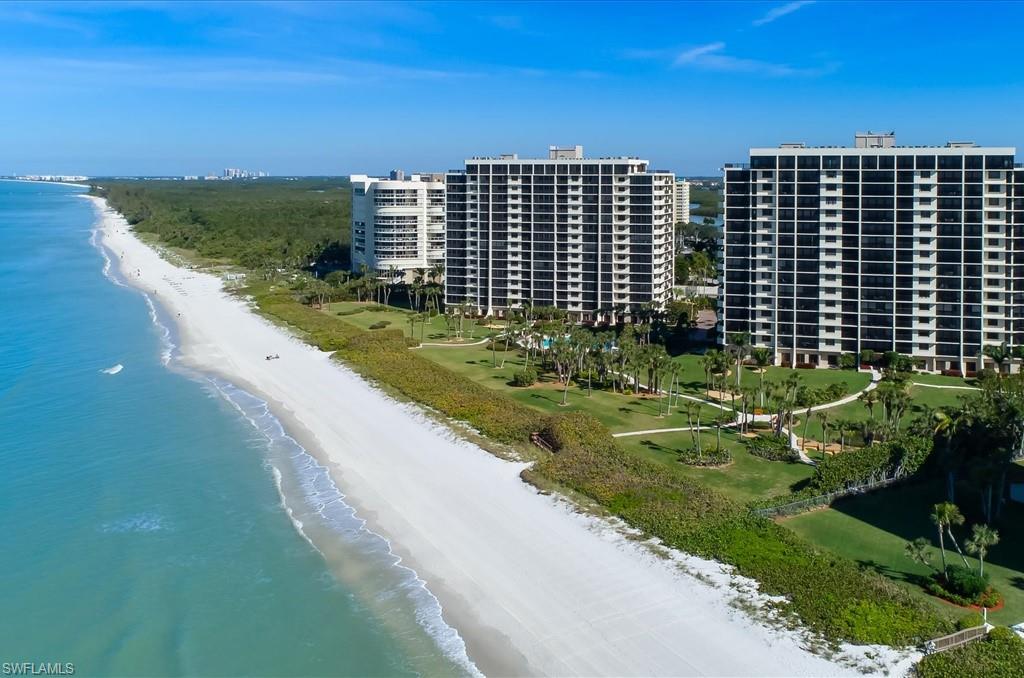 Drone / aerial view of expansive coastline and apartment complex / building