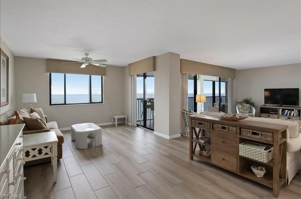 Living room with light wood-style floors and ceiling fan
