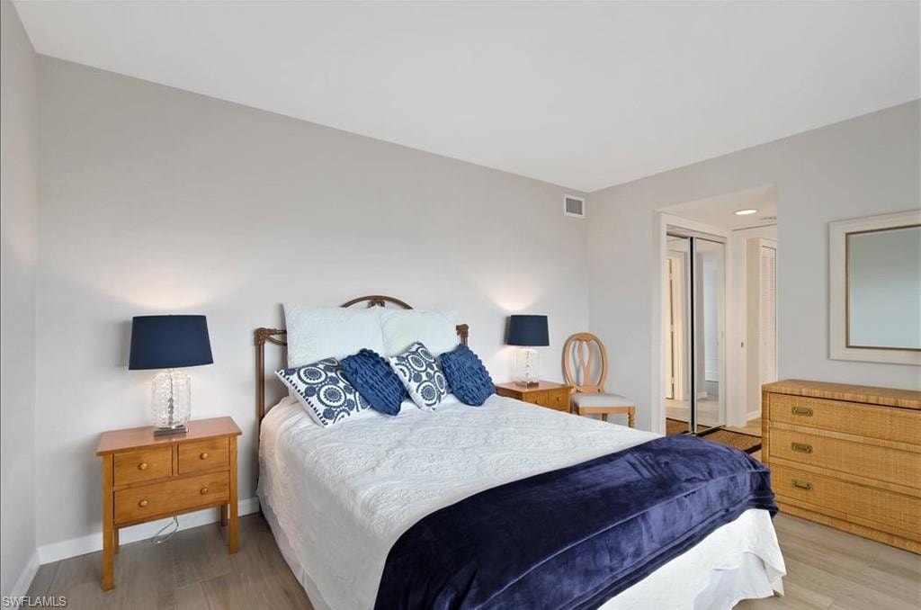 Bedroom featuring wood finished floors and a closet