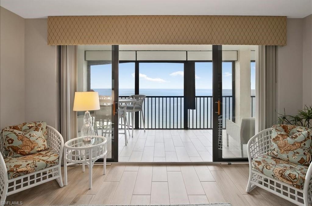 Doorway with a water view and wood finished floors